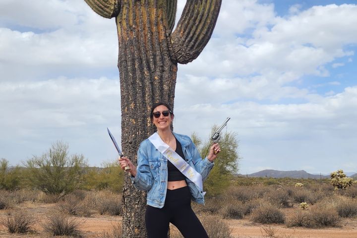 a person standing in front of a cactus